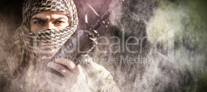 Composite image of portrait of soldier holding a rifle