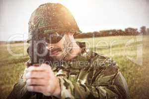 Composite image of portrait of soldier aiming with rifle