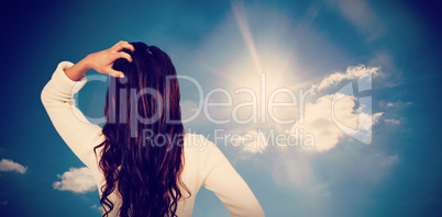 Composite image of rear view of confused woman with hand in hair
