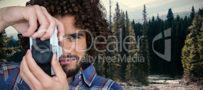 Composite image of portrait of male photographer taking picture