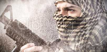 Composite image of close up of soldier with rifle looking away