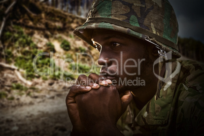 Composite image of close up of thoughtful soldier