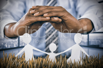 Composite image of family protected by a roof