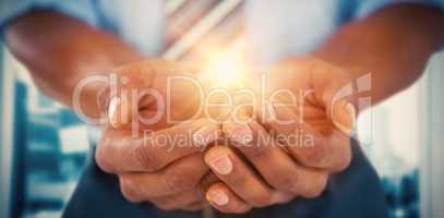 Composite image of businessman with hands cupped