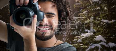 Composite image of close up of happy man photographing with camera