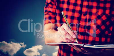 Composite image of hipster taking notes on notebooks