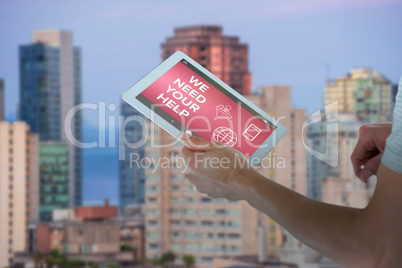 Composite image of man holding digital tablet