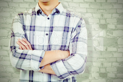 Composite image of mid section of man with arms crossed