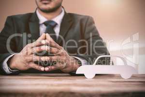 Composite image of business man sitting behind a desk