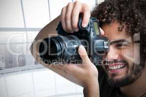 Composite image of close up of cheerful male photographer taking picture with camera