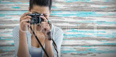 Composite image of close up of female photographer taking picture