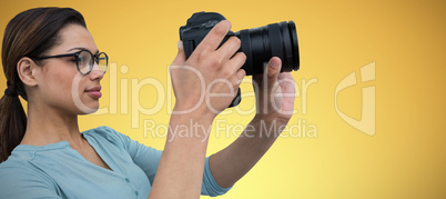 Composite image of young woman photographing with digital camera