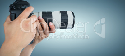 Composite image of cropped hands of photographer holding digital camera