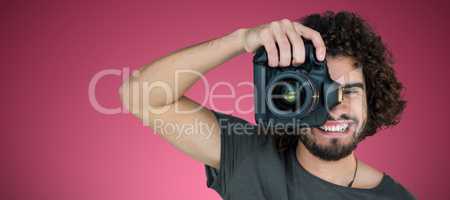 Composite image of happy male photographer photographing through camera