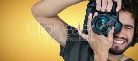 Composite image of smiling male photographer taking picture