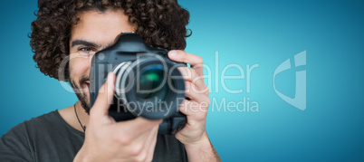 Composite image of close up portrait of male photographer taking picture