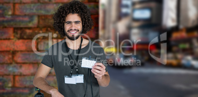 Composite image of portrait of smiling male photographer holding identity card