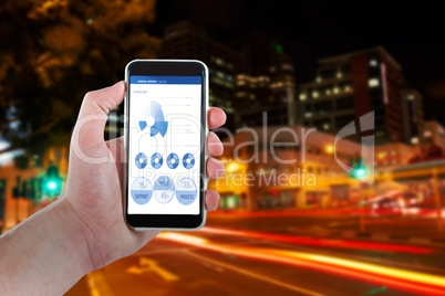 Composite image of cropped hand holding mobile phone