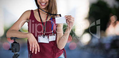 Composite image of portrait of happy woman holding identity card