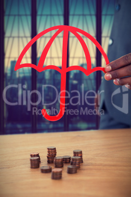 Composite image of hand holding a red umbrella