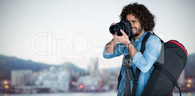 Composite image of full length of male photographer taking picture
