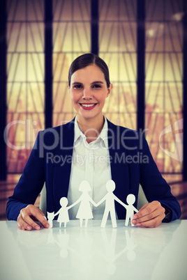 Composite image of family in white paper with a woman in the background