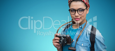 Composite image of portrait of female photographer with camera
