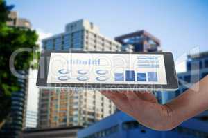 Composite image of human hand holding digital tablet against white background