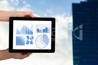 Composite image of close-up of hands holding digital tablet