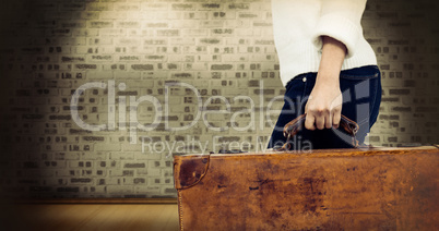 Composite image of low section of woman carrying vintage suitcase