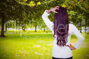 Composite image of rear view of confused woman with hand in hair
