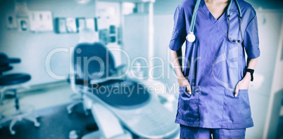 Composite image of asian nurse with hands in pocket