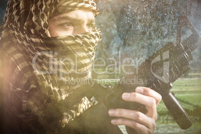 Composite image of close up of soldier with rifle looking away