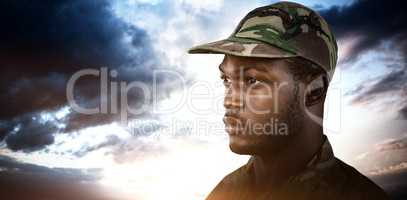Composite image of thoughtful soldier wearing cap while standing