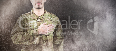 Composite image of mid section of soldier taking oath