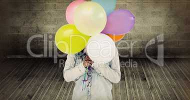 Composite image of woman hiding her face with bunch of colorful balloons