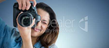 Composite image of young woman photographing through camera