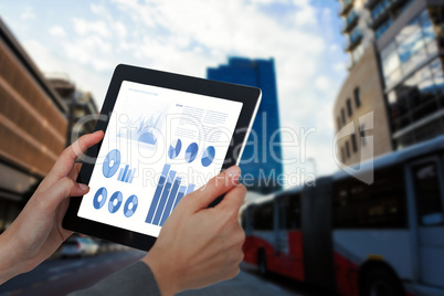 Composite image of cropped image of businesswoman holding digital tablet