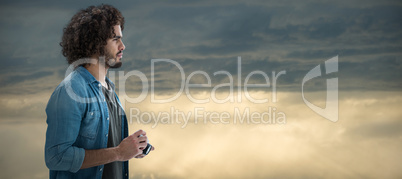 Composite image of thoughtful male photographer holding camera