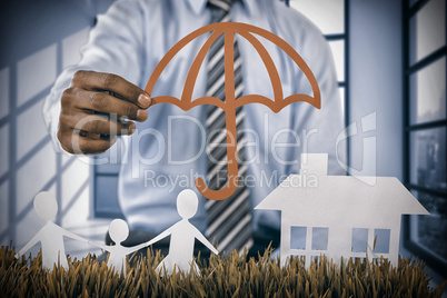 Composite image of insurer protecting family by a red umbrella