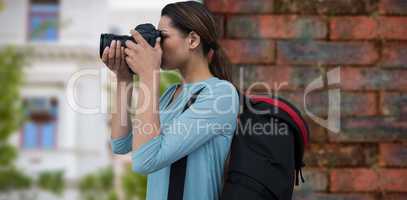 Composite image of side view of woman photographing through digital camera