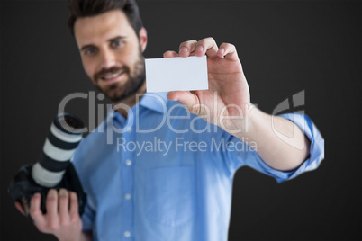 Composite image of happy man showing identity card while holding camera