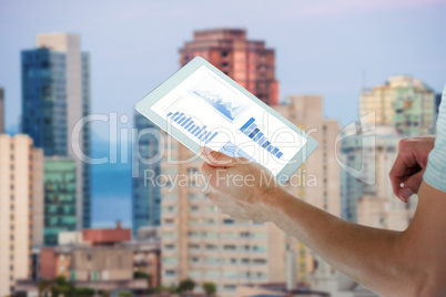 Composite image of man holding digital tablet