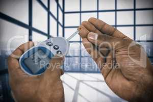 Composite image of close up of man hands testing blood sugar with glucometer