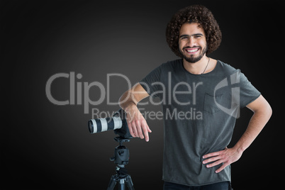 Composite image of portrait of happy male photographer with camera and tripod