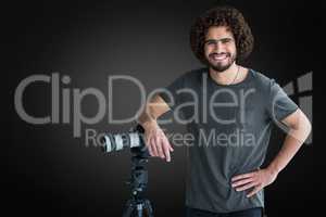 Composite image of portrait of happy male photographer with camera and tripod