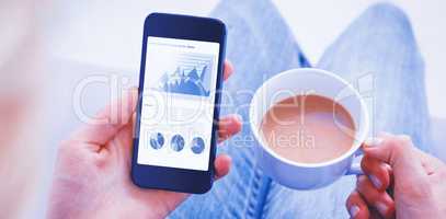 Composite image of woman using her mobile phone and holding cup of coffee