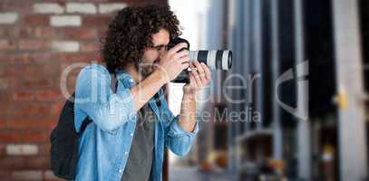 Composite image of professional male photographer taking picture