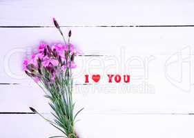 Bouquet of pink field carnations and inscription I love you