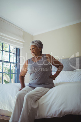 Senior woman suffering from back pain at home